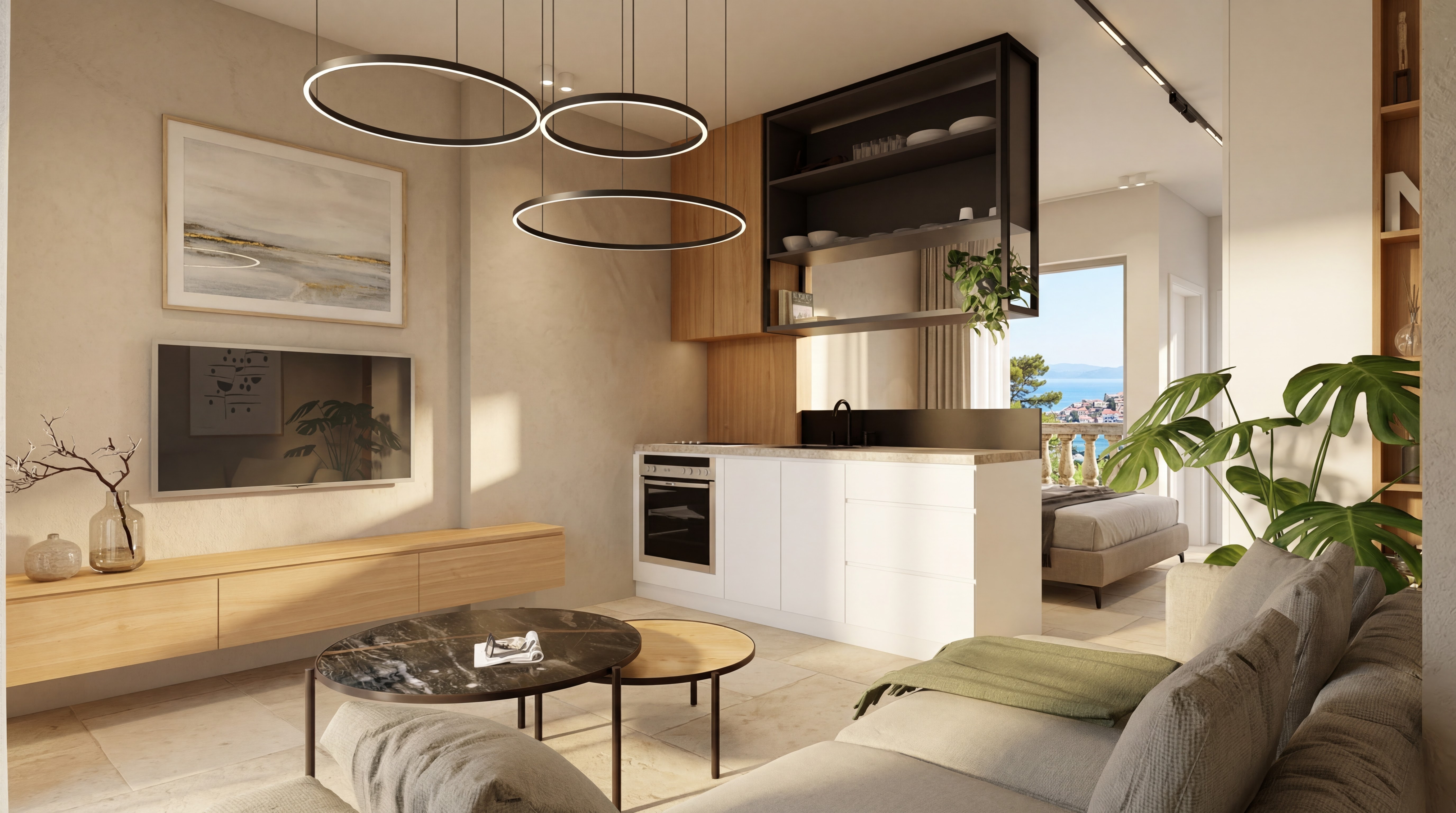 Realistic Studio Deluxe concept showing the open living area, kitchen island, sofa, TV wall, and bedroom beyond